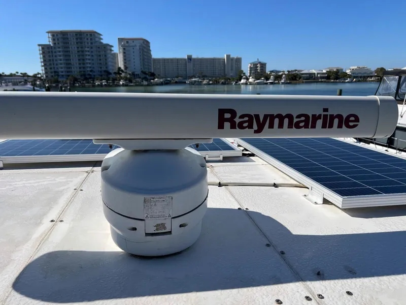 Slide: The Image of Raymarine radar on 1983 Lindmark 39 Trawler with solar panels, cityscape in background. - 22