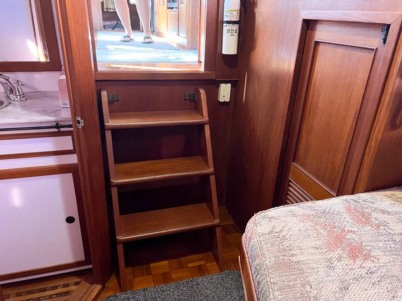 Slide: The Image of Interior of 1983 Lindmark 39 Trawler with wooden steps and cozy cabin features. - 37