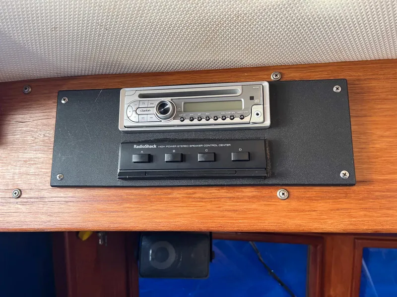 Slide: The Image of 1983 Lindmark 39 Trawler radio and control panel on wooden dashboard. - 44