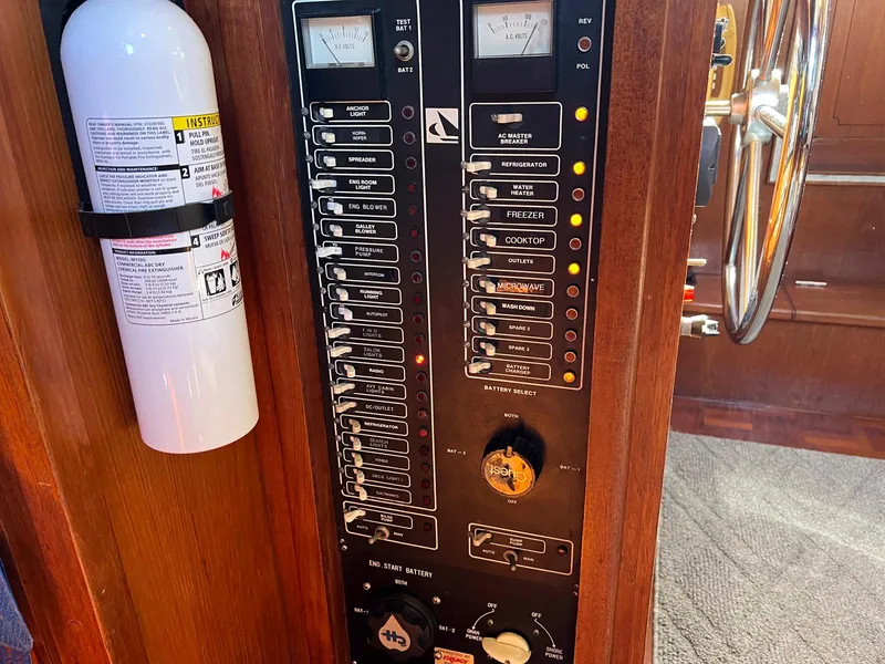 Slide: The Image of Control panel of 1983 Lindmark 39 Trawler with fire extinguisher and steering wheel visible. - 47