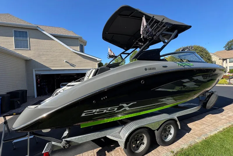 Slide: The Image of 2021 Yamaha Boats 255XD on trailer, parked in residential driveway. - 1