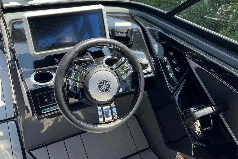 Slide: The Image of 2021 Yamaha Boats 255XD dashboard with steering wheel and control panel. - 25