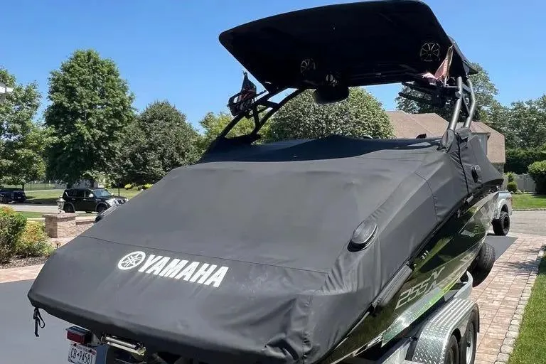 Slide: The Image of 2021 Yamaha Boats 255XD covered on trailer in residential driveway. - 34
