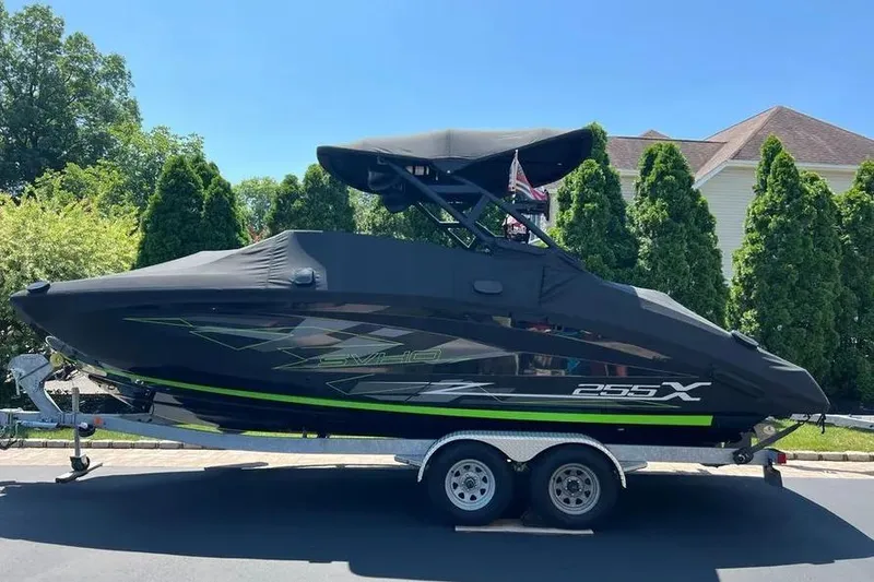Slide: The Image of 2021 Yamaha Boats 255XD on trailer, covered, parked outdoors. - 4
