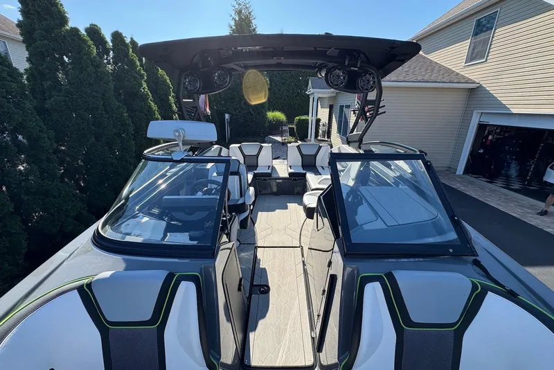 Slide: The Image of 2021 Yamaha Boats 255XD with sleek design and modern interior, parked in driveway. - 9