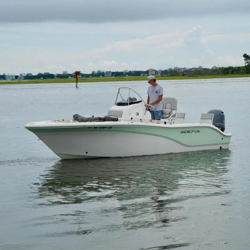 Slide: The Image of 2020 Sea Fox 186 Commander boat on calm water with a person onboard. - 2