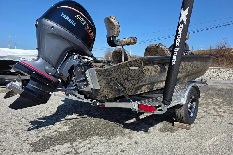 Slide: The Image of 2026 Xpress H18 Bass boat with Yamaha engine on trailer, camo design. - 10