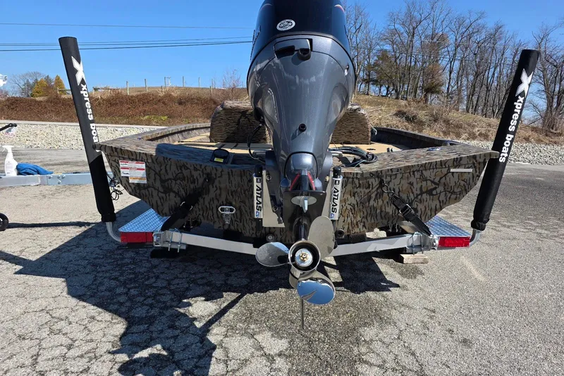 Slide: The Image of 2026 Xpress H18 Bass boat with camo design and powerful outboard motor. - 12