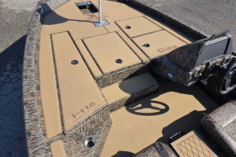 Slide: The Image of 2026 Xpress H18 Bass boat with camo design and SeaDek flooring. - 14