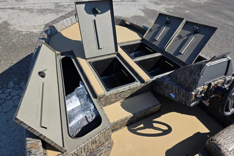 Slide: The Image of 2026 Xpress H18 Bass boat interior with open storage compartments and steering console. - 15