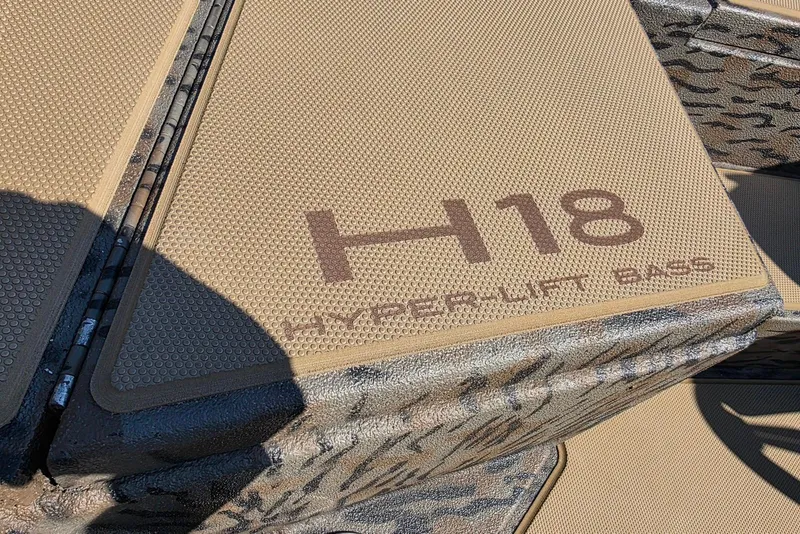 Slide: The Image of 2026 Xpress H18 Bass boat deck with Hyper-Lift branding, textured surface. - 16