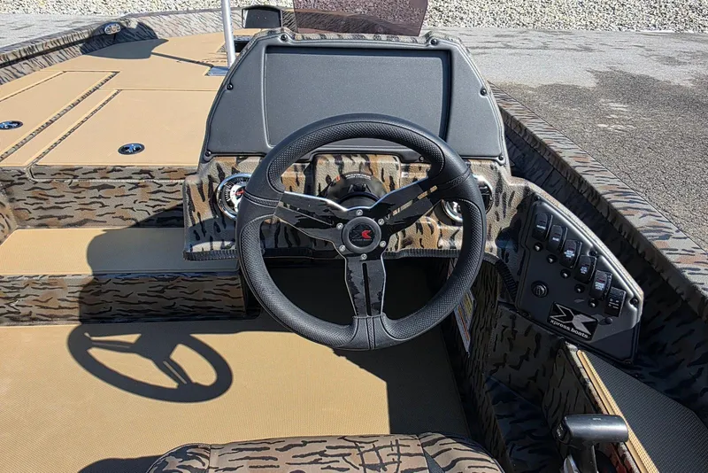 Slide: The Image of 2026 Xpress H18 Bass boat interior with camo design and steering wheel. - 21