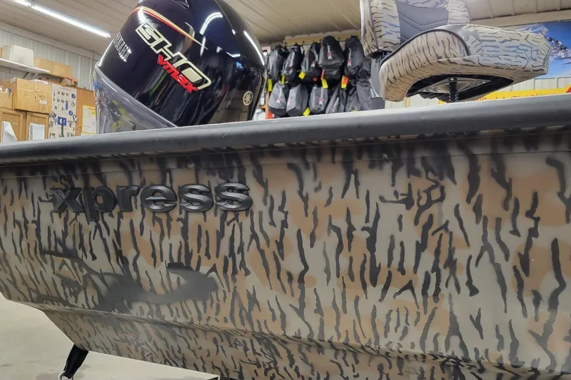 Slide: The Image of 2026 Xpress H18 Bass boat with camo design and Yamaha VMAX engine. - 6