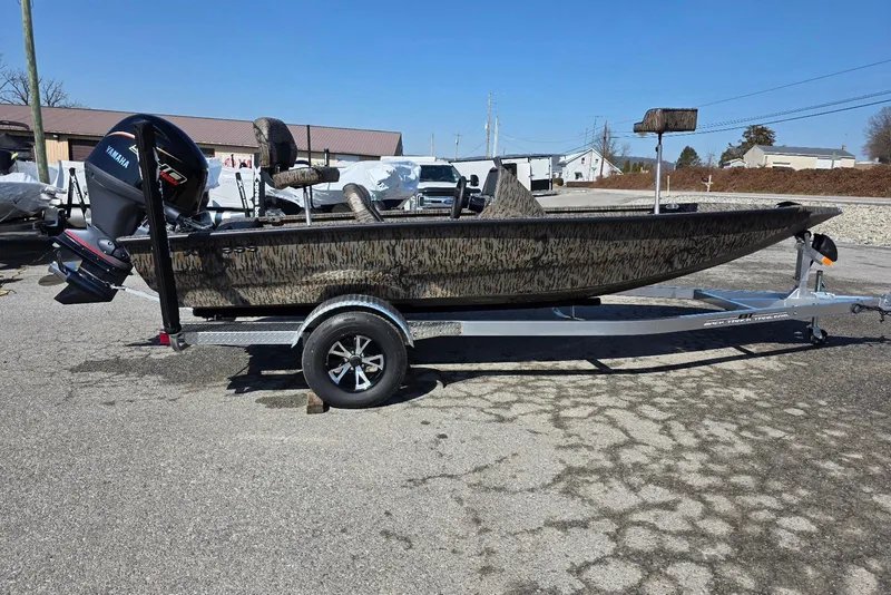 The Image of 2026 Xpress H18 Bass boat on trailer, featuring camouflage design and Yamaha outboard motor. - 7