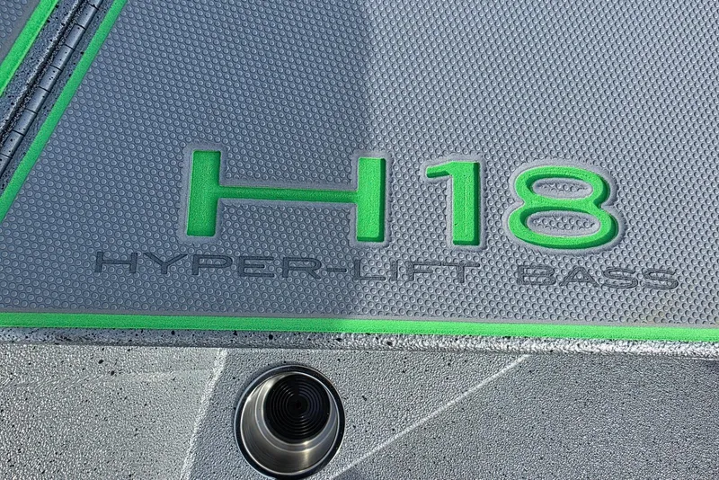 Slide: The Image of 2026 Xpress H18 Bass boat logo with green accents on textured surface. - 13