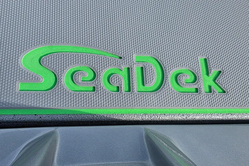 Slide: The Image of SeaDek logo on 2026 Xpress H18 Bass boat deck, featuring textured gray and green design. - 14