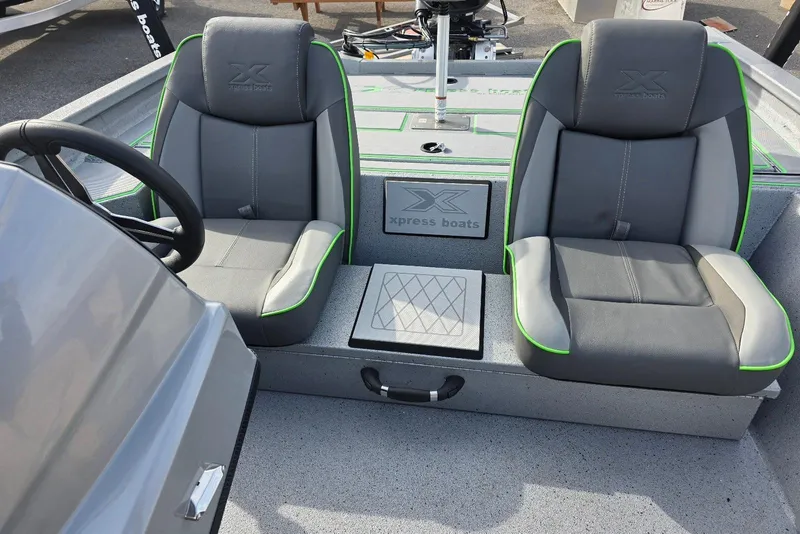 Slide: The Image of 2026 Xpress H18 Bass boat interior with two gray seats and green accents. - 18