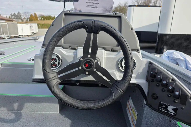 Slide: The Image of Steering wheel of 2026 Xpress H18 Bass boat with dashboard controls. - 19