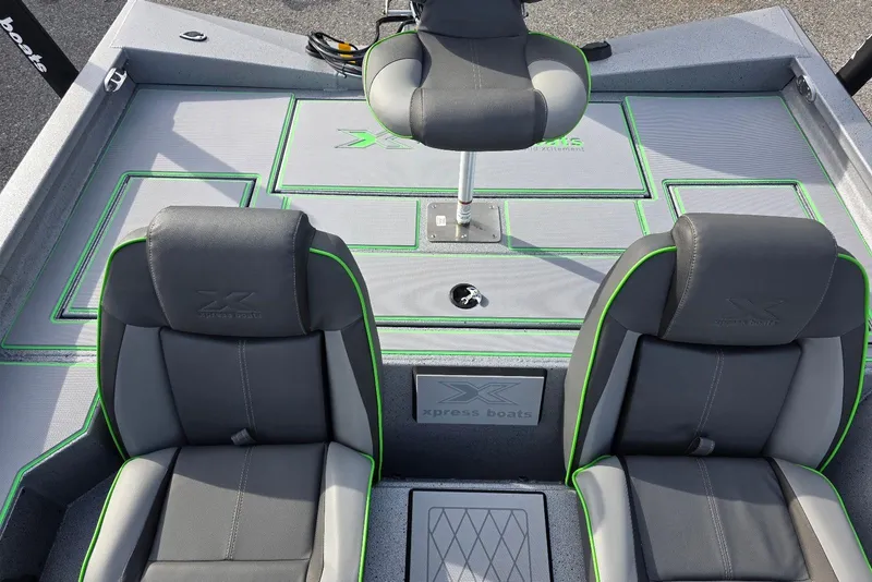Slide: The Image of 2026 Xpress H18 Bass boat interior with gray and green seating and deck. - 20