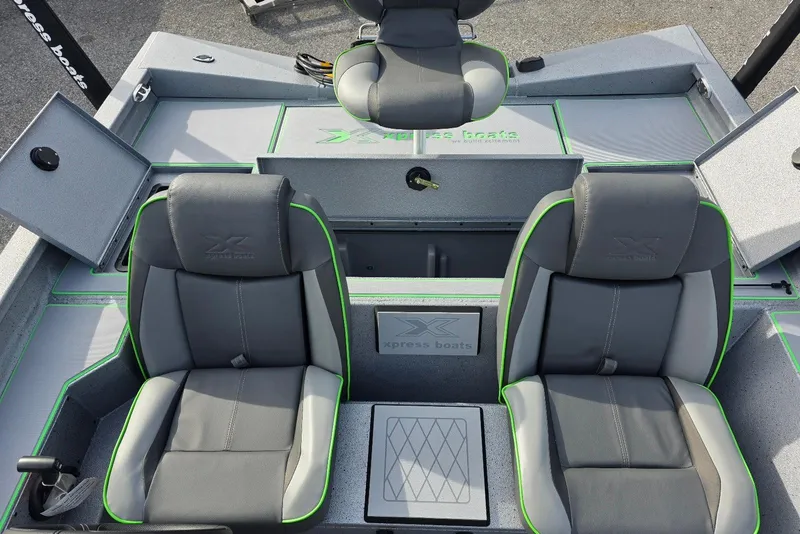 Slide: The Image of 2026 Xpress H18 Bass boat interior with gray and green seating, showcasing modern design. - 21