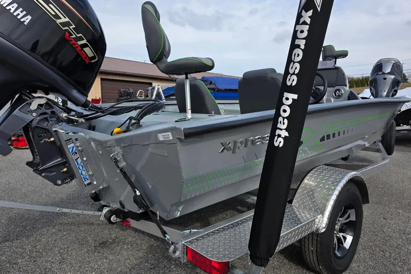 Slide: The Image of 2026 Xpress H18 Bass boat with Yamaha engine on trailer, featuring sleek design and modern seating. - 8
