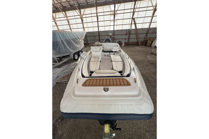 Slide: The Image of 2024 Walker Bay Generation 525 boat in storage, showcasing sleek design and spacious seating. - 11