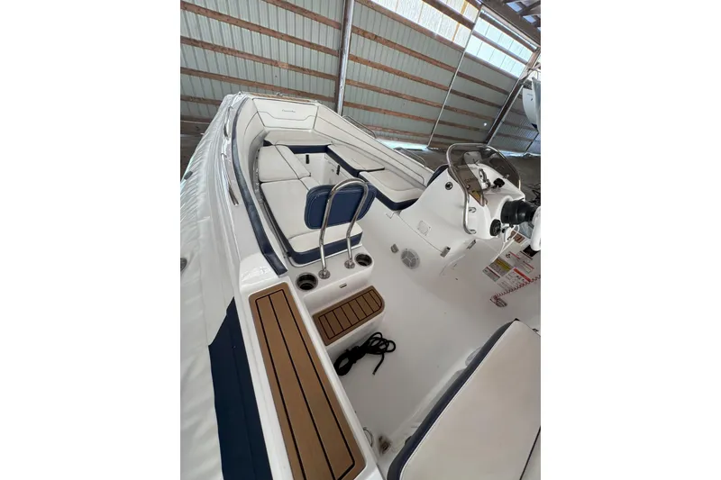 Slide: The Image of 2024 Walker Bay Generation 525 boat interior with seating and steering console. - 14