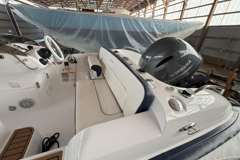Slide: The Image of 2024 Walker Bay Generation 525 boat interior with Yamaha engine in a storage facility. - 16