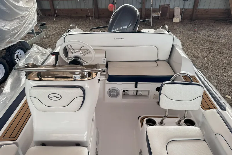 Slide: The Image of 2024 Walker Bay Generation 525 boat interior with steering wheel and seating. - 18