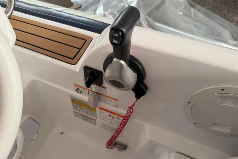 Slide: The Image of 2024 Walker Bay Generation 525 boat control panel with throttle lever and safety features. - 21