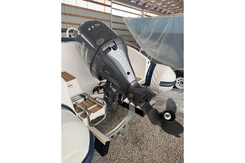 Slide: The Image of 2024 Walker Bay Generation 525 boat with Yamaha 115 outboard motor in storage. - 23