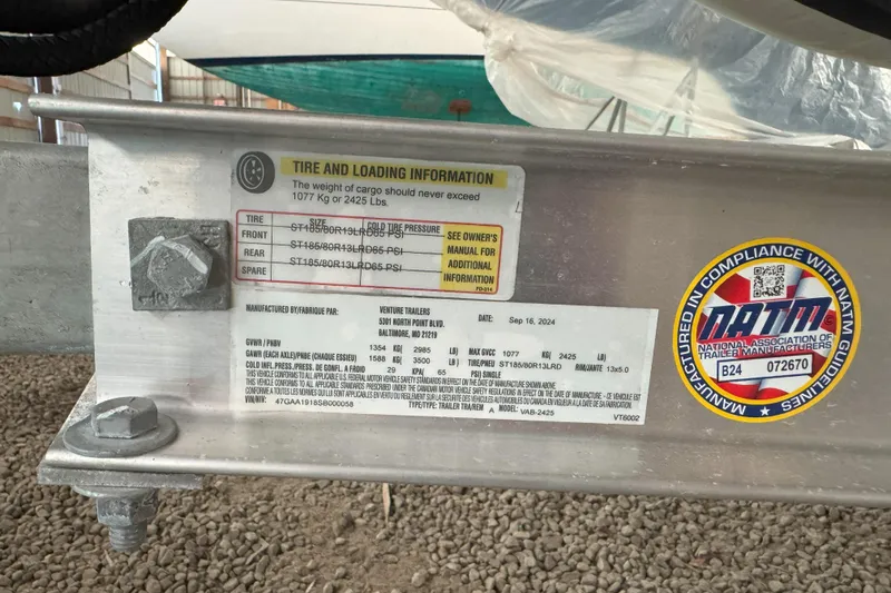 Slide: The Image of 2024 Walker Bay Generation 525 trailer tire and loading information label with NATM compliance sticker. - 26