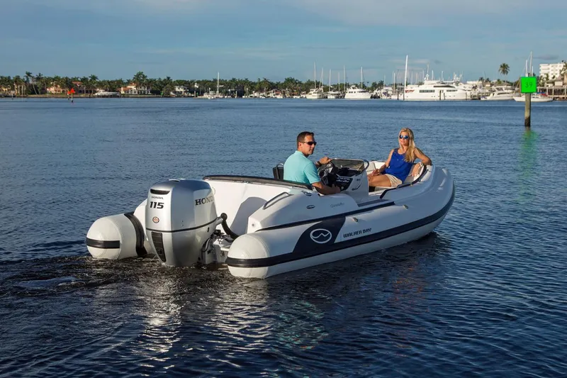 Slide: The Image of Manufacturer Provided Image: 2024 Walker Bay Generation 525 DLX boat cruising on calm waters. - 5