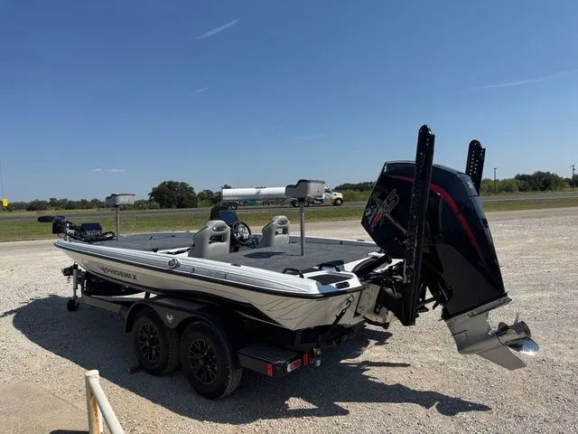 Slide: The Image of 2026 Phoenix 921 Elite X boat on trailer, parked outdoors under clear blue sky. - 7