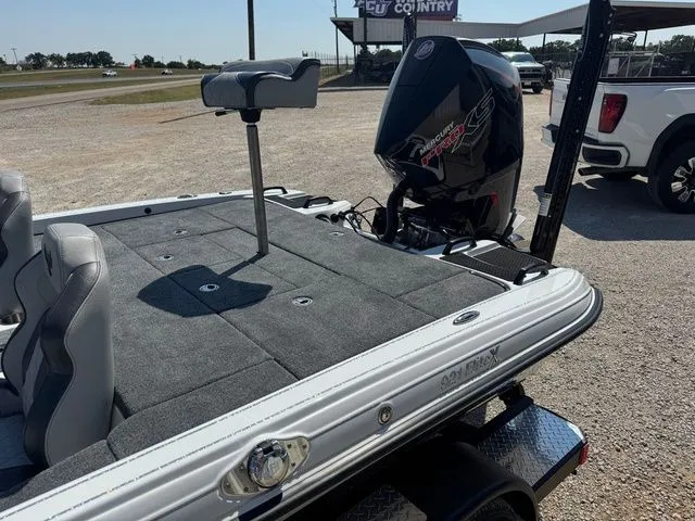 Slide: The Image of 2026 Phoenix 921 Elite X boat with motor, parked on gravel lot. - 9