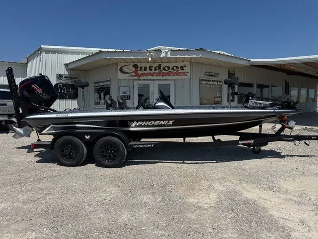 The Image of 2026 Phoenix 920 Elite X boat parked outside a dealership under clear blue skies. - 1