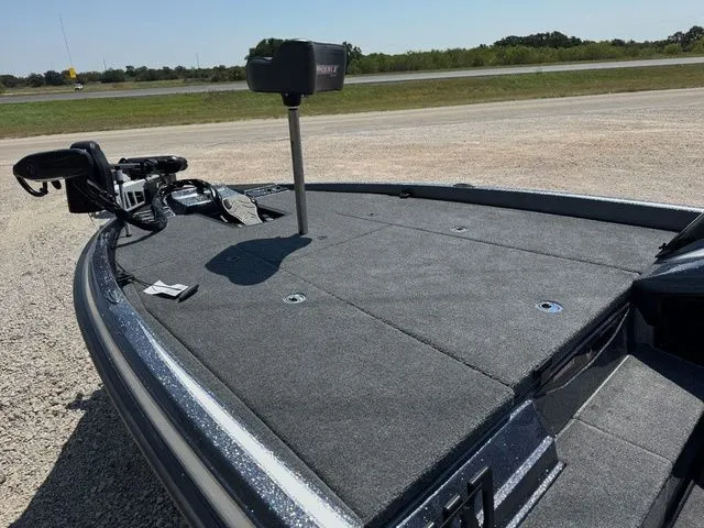 Slide: The Image of 2026 Phoenix 920 Elite X boat deck with fishing equipment on a sunny day. - 10