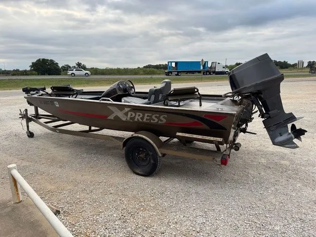 Slide: The Image of 2001 Xpress X51 boat on trailer, parked outdoors on gravel. - 5