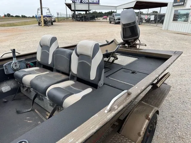 Slide: The Image of 2001 Xpress X51 boat with three seats and steering wheel, parked outdoors. - 7