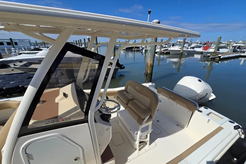 Slide: The Image of 2019 Scout 235 XSF boat docked at marina with Yamaha engine. - 17