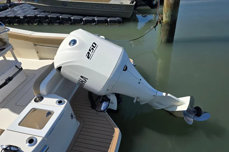 Slide: The Image of 2019 Scout 235 XSF boat with Yamaha 250 outboard motor docked in marina. - 18