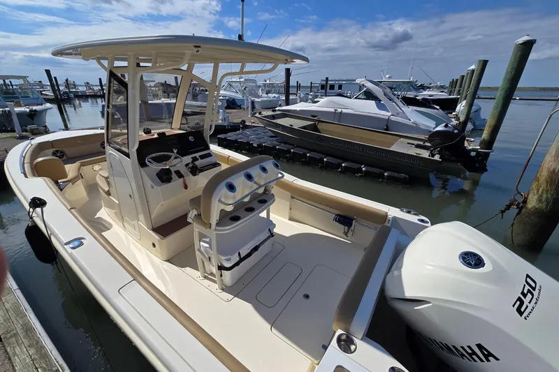 Slide: The Image of 2019 Scout 235 XSF boat docked, featuring Yamaha 250 engine, in a marina setting. - 19