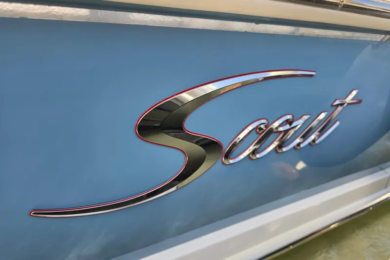 Slide: The Image of 2019 Scout 235 XSF boat logo on blue hull, chrome lettering. - 2