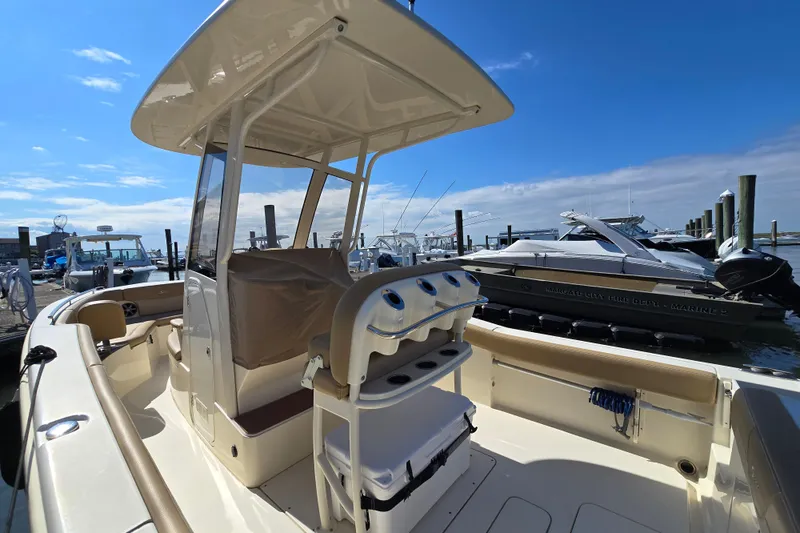 Slide: The Image of 2019 Scout 235 XSF boat docked at marina under clear blue sky. - 21