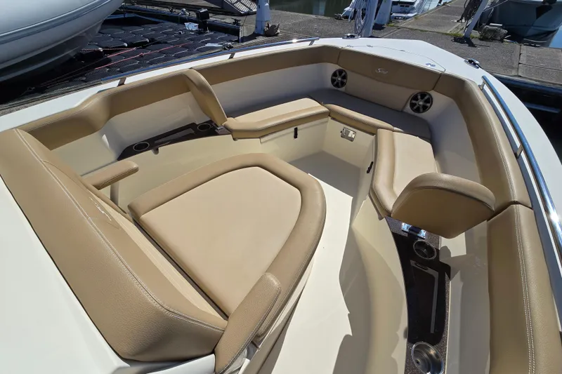 Slide: The Image of 2019 Scout 235 XSF boat interior with tan seating and cup holders. - 7