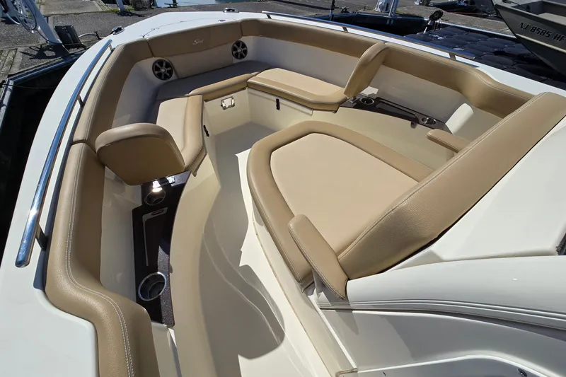 Slide: The Image of 2019 Scout 235 XSF boat interior with beige seating and cup holders. - 8