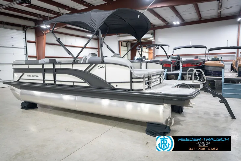 Slide: The Image of 2026 Bennington 22 SSB pontoon boat in showroom with canopy and sleek design. - 10