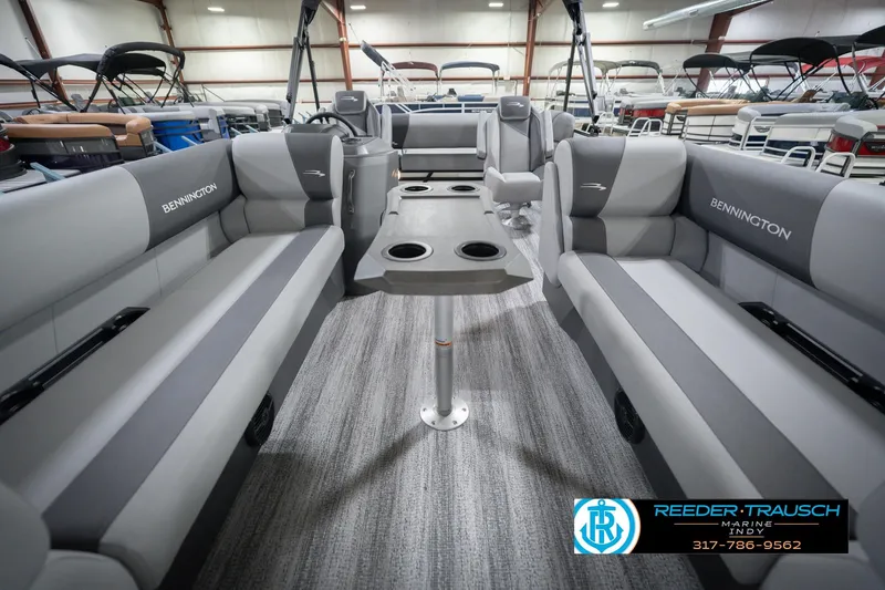 Slide: The Image of 2026 Bennington 22 SSB pontoon boat interior with gray seating and central table. - 16