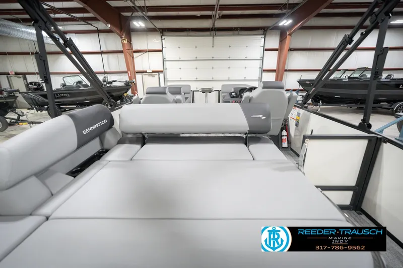 Slide: The Image of 2026 Bennington 22 SSB pontoon boat interior with gray seating in a showroom. - 19
