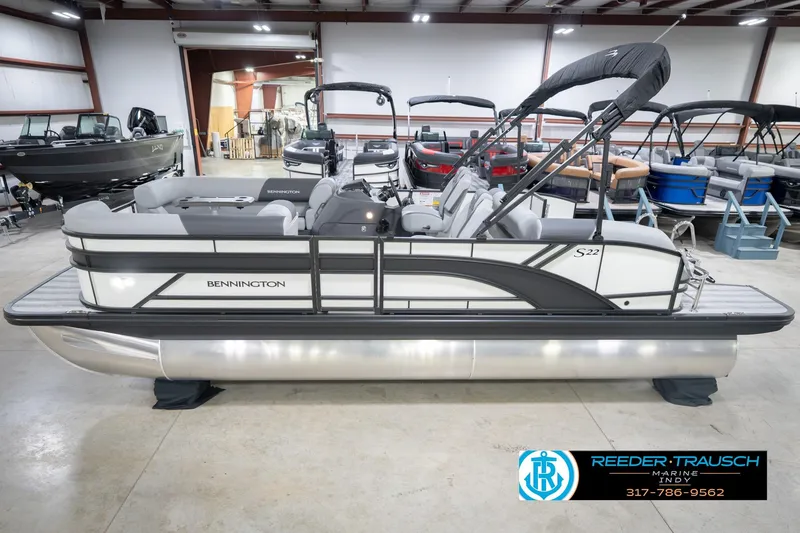 Slide: The Image of 2026 Bennington 22 SSB pontoon boat in showroom, side view. - 2